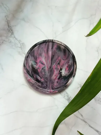 The dramatic blend of black and pink in this coaster creates a unique, smoky effect. Each one is a durable and eco-conscious alternative to conventional coasters.
