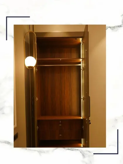 Our wardrobes aren’t just for storage; they’re an experience. This image shows a beautifully crafted wooden wardrobe with an elegant pendant light, reflecting a perfect blend of style and organization.