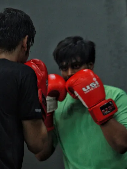 Two boxers focused entirely on each other during a drill. This sport demands your full attention. When you're in here, the outside world disappears.