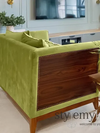 I believe custom furniture is key to a unique home. This green velvet sofa with a solid wood back is a piece we designed to be both a statement and a comfortable anchor for the living room.
