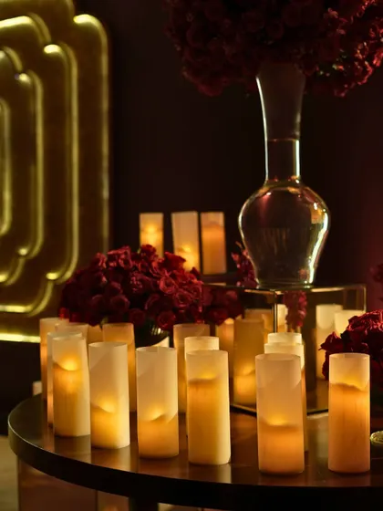 A close-up of the candle and floral decor, showcasing the warm, amber lighting that defined the evening's mood.