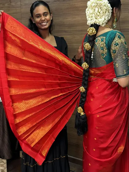 The final look of a bridal saree drape, with the pleats fanned out beautifully. This is a classic photo that brides love.