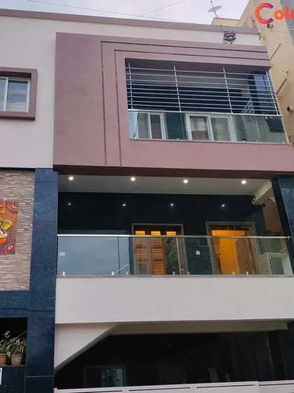 A recently completed exterior painting project in Bangalore. The combination of a muted mauve, dark stone cladding, and white trim gives this modern home a sophisticated and contemporary look.