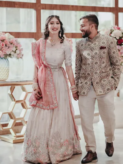 A joyful shot of the couple walking hand-in-hand at their engagement. The bright, airy feel of the photo reflects the happy atmosphere of the day.