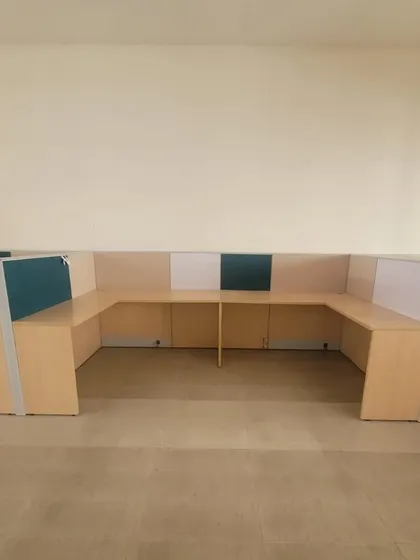 A U-shaped configuration of modular workstations. This setup is ideal for teams that need to collaborate closely while still having their own defined desk space.