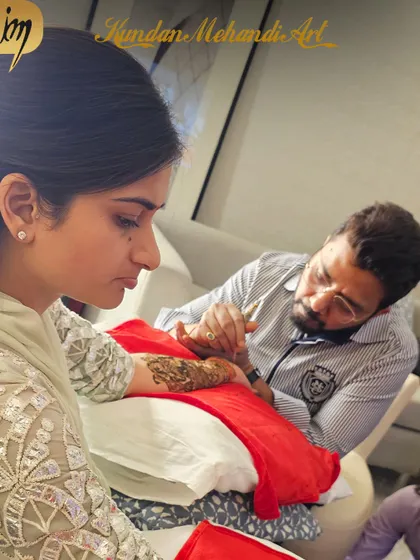 A photo of me completely focused on my craft, ensuring every line is perfect for the bride's special day.