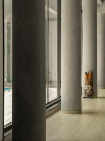Interior views of the gallery-like spaces, where concrete columns and walls create a neutral yet powerful backdrop for art. The play of light from skylights and windows animates the surfaces.