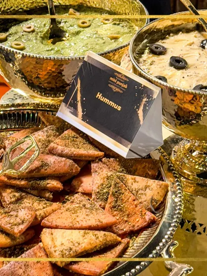 Dip into the rich, creamy goodness of our hummus, served in elegant golden bowls with freshly baked pita. We bring culinary artistry and global flavours to your table.