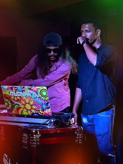 On stage with a fellow artist, collaborating to create a unique live performance.