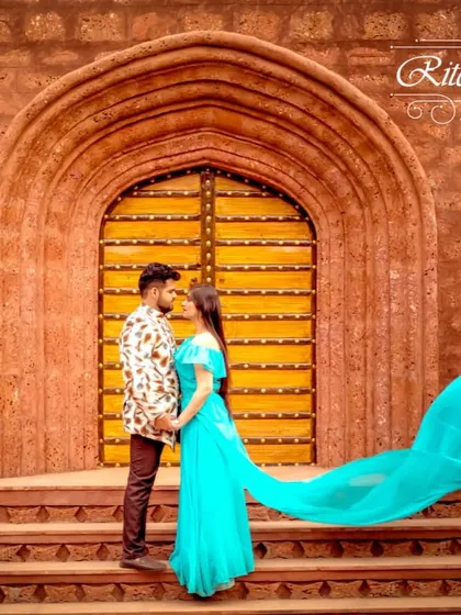 An example of a beautiful Indo-western pre-wedding look. The bride-to-be wears a flowing turquoise gown, while the groom-to-be complements her in a patterned jacket. This is a great rental choice for a unique, modern-ethnic theme.