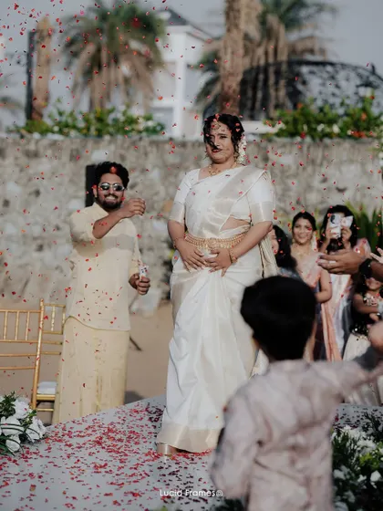 The bride's entrance, showered with petals by her loved ones. A beautiful, candid moment full of tradition and joy.