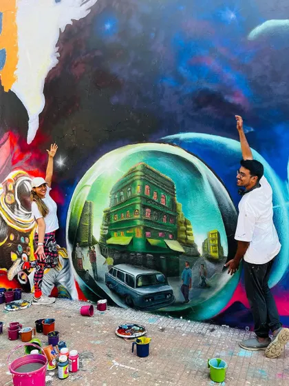 A moment of celebration with my collaborator in front of a nearly finished section of the IIT Bombay mural. Teamwork is essential to bringing such a large vision to life.