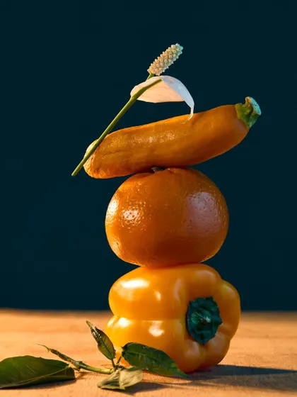 Another composition from my "Fru-Veg" series, this time stacking produce in shades of yellow and orange. The single white flower adds a touch of elegance to the playful, sculptural arrangement.