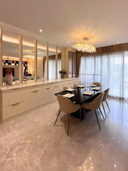 A different perspective of this elegant dining room, showing the beautiful marble flooring and the way natural light from the large windows fills the space. The design is clean, luxurious, and inviting.