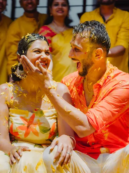 A candid moment of pure joy between the couple during their Haldi ceremony, surrounded by friends and family.
