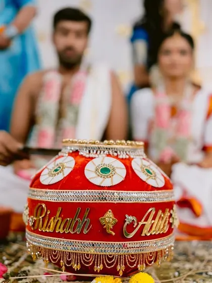 A detail shot of the decorated pot, personalized with the couple's names, used in the wedding rituals.