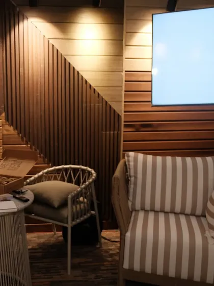 A closer look at the seating area in our Bhubaneswar expo booth. The mix of textures, from the wooden walls to the woven chairs, creates a warm and inviting feel.