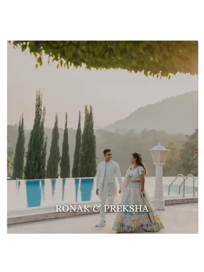 A serene couple portrait by the pool against a backdrop of mountains. This shot, taken during their Haldi event, has a calm and picturesque quality.