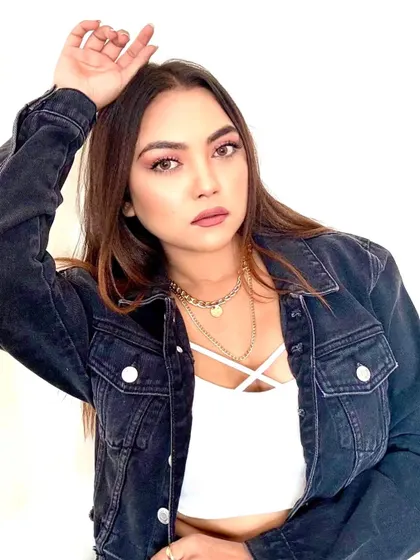 A classic look with a denim jacket and layered necklaces.