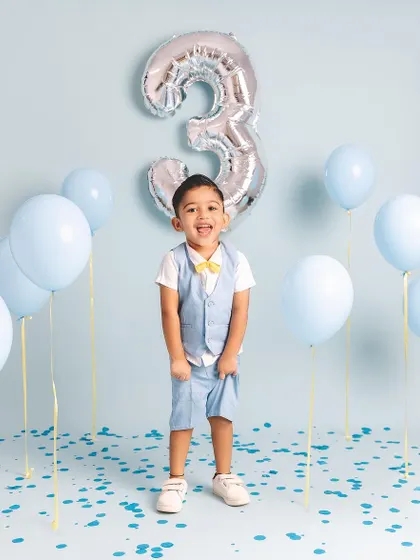 This little guy is so excited to be three! His energetic pose and happy shout are perfectly captured in this fun birthday portrait.