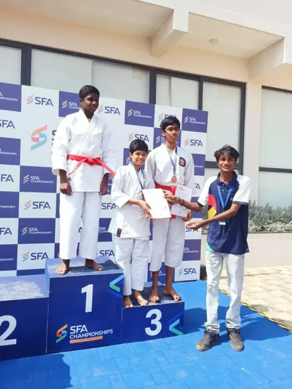 My student on the third-place podium receiving his bronze medal and certificate at the SFA Championships.
