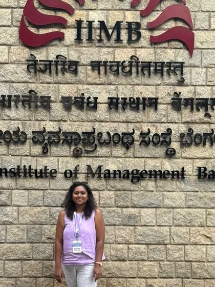 A duplicate of 55 and 57, a photo in front of the IIMB sign.