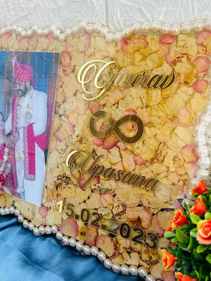 The soft yellow and pink hues of the preserved rose petals give this frame a warm and gentle look, perfect for a wedding keepsake.