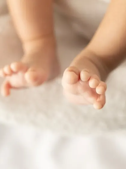Another beautiful shot of tiny baby toes. The soft lighting and simple background keep the focus on this precious detail.
