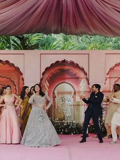 Amidst the grandeur of the Rajput palace-themed stage, the couple shares a playful dance. These are the candid, joyful moments that make a wedding celebration truly special.