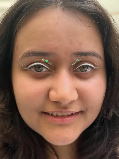 A duplicate image for context. A creative look using a white graphic liner and green glitter on the inner corners.