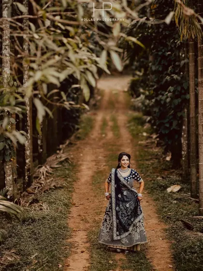 A beautiful full-length portrait of a bride in an ornate lehenga on a rustic path. The natural leading lines of the path draw all the attention to her.