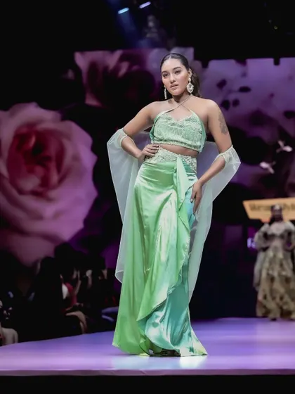 Capturing the flow and elegance of this pastel green ensemble at Bangalore Fashion Week. The soft lighting and floral background complement the outfit's delicate design, creating a romantic and ethereal runway moment.