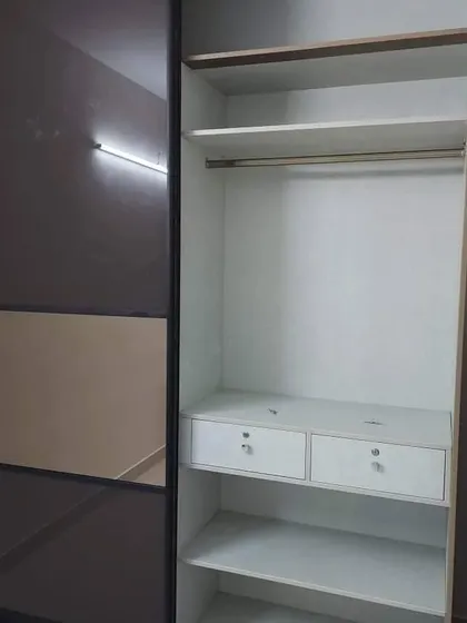 A look inside our custom sliding wardrobe. We plan the internal layout with a mix of hanging space, shelves, and lockable drawers to meet your specific storage needs.