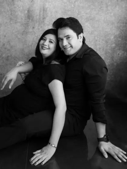 A classic black and white portrait of an expecting couple. Monochrome photos offer a timeless feel, focusing entirely on expression and connection.