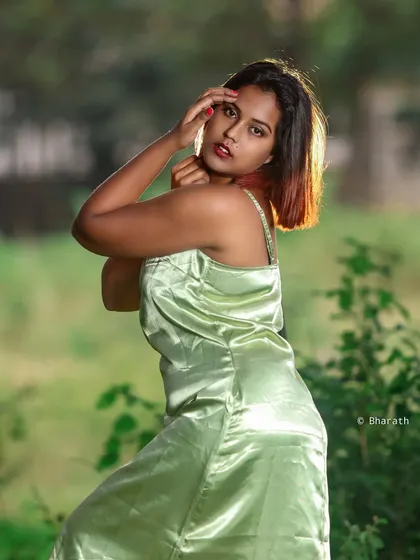 An outdoor editorial shot with a satin dress. The backlighting from the sun highlights the subject and creates a beautiful glow.