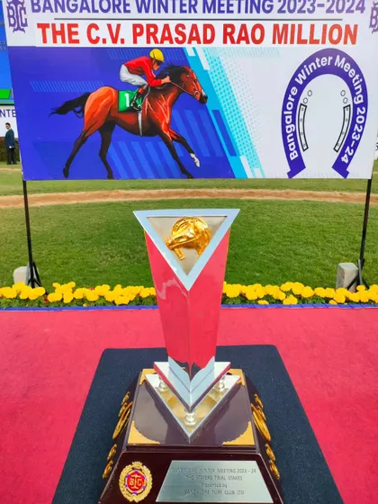 The Stayers' Trial Stakes trophy, a modern triangular silver cup with a crown-like top.