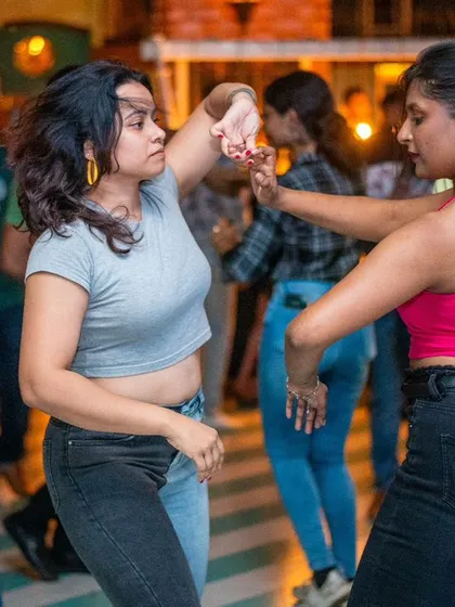 Two friends dancing together and having a great time.