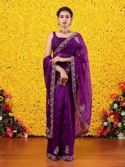 The full, standing view of the embroidered purple organza saree, a true statement piece.