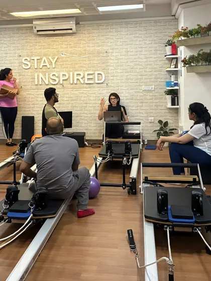 The learning process is a mix of theory and practice. Here, we take a break from the physical work to discuss programming and client assessment, ensuring our new instructors are well-rounded professionals.
