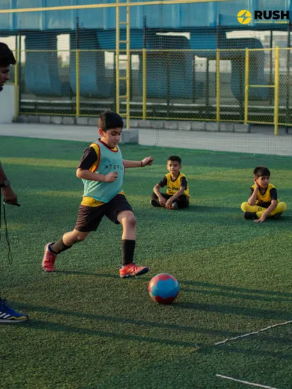 A coach provides instruction to a player during a drill.