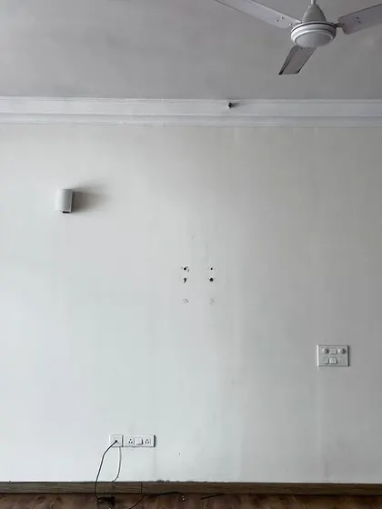 Before: A plain living room wall with basic fixtures. This was the starting point for our 'Cover me in Sunshine' project.