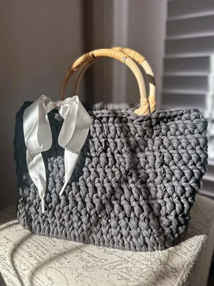 I love how the sunlight catches this grey T-shirt yarn bag. I added a white satin ribbon for a touch of softness.