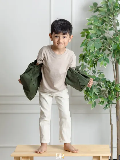 A cool and casual portrait of a young boy, full of personality and charm.