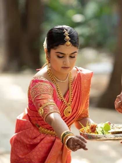 Another moment from the wedding ceremony, showcasing the bride's elegant look as she participates in the rituals.