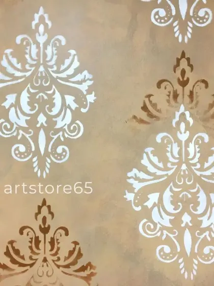 A close-up of the classic damask pattern. We use both silver and bronze metallic paints to create a rich, layered effect on this bedroom accent wall, giving it a truly royal finish.