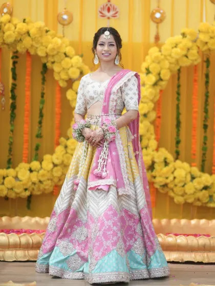 A smiling portrait of the bride. Her makeup is fresh and dewy, with a focus on a natural, radiant glow.