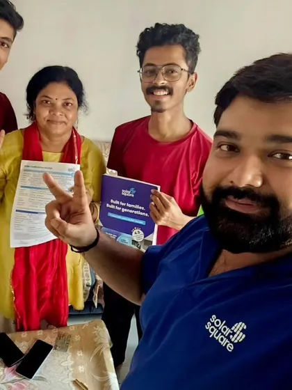 Our team member takes a selfie with a family giving the victory sign. Another win for clean energy and lower electricity bills.