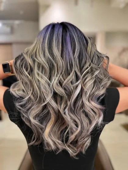 This is my 'Winter Frost' look. I combined cool ash tones with a peekaboo of purple for a unique and trendy style. This look uses bleach to achieve those icy blonde and pastel purple shades.