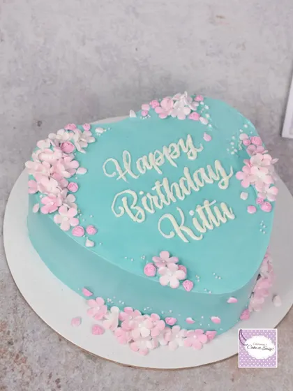 This heart-shaped cake may look simple, but it's covered in nearly 80 tiny, handmade fondant cherry blossoms. It was a labour of love, and I'm thrilled with the delicate result.