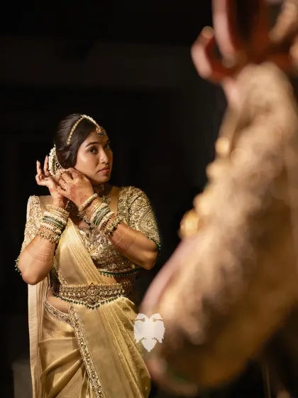 Gold that tells a story. Bride Aparna getting ready, her full gold raw silk blouse the epitome of bridal opulence.